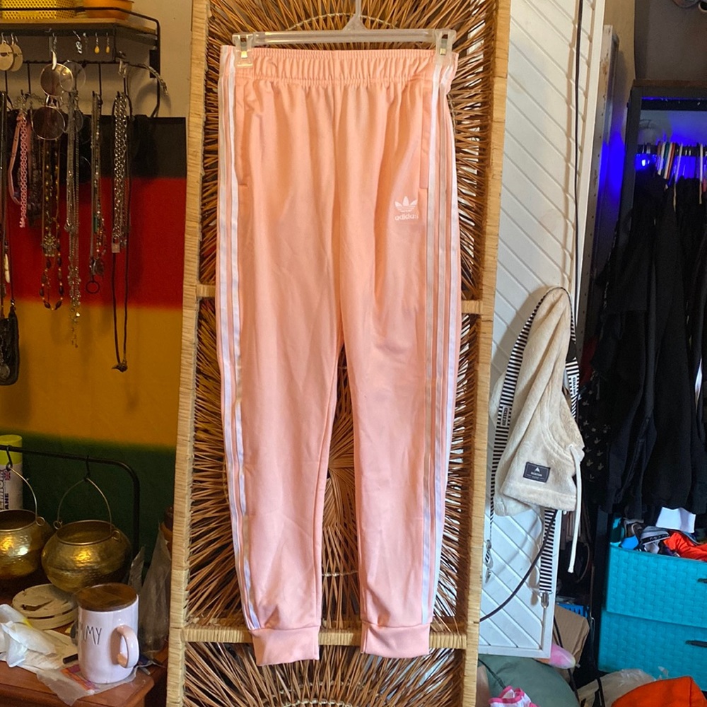 NWOT pink adidas joggers with three stripe detail on leg and logo on hip